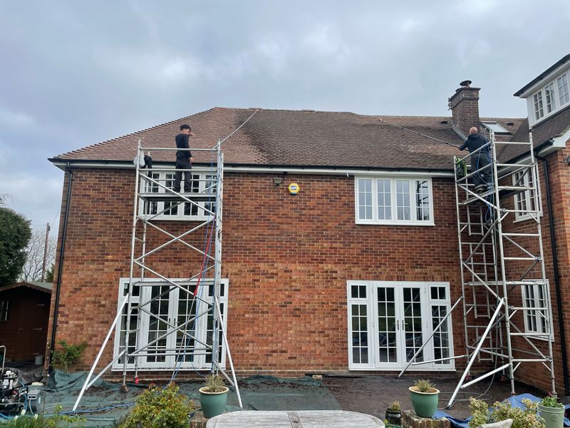 Roof cleaning carried out safely from scaffold towers by The Roof Moss Cleaners in Chertsey